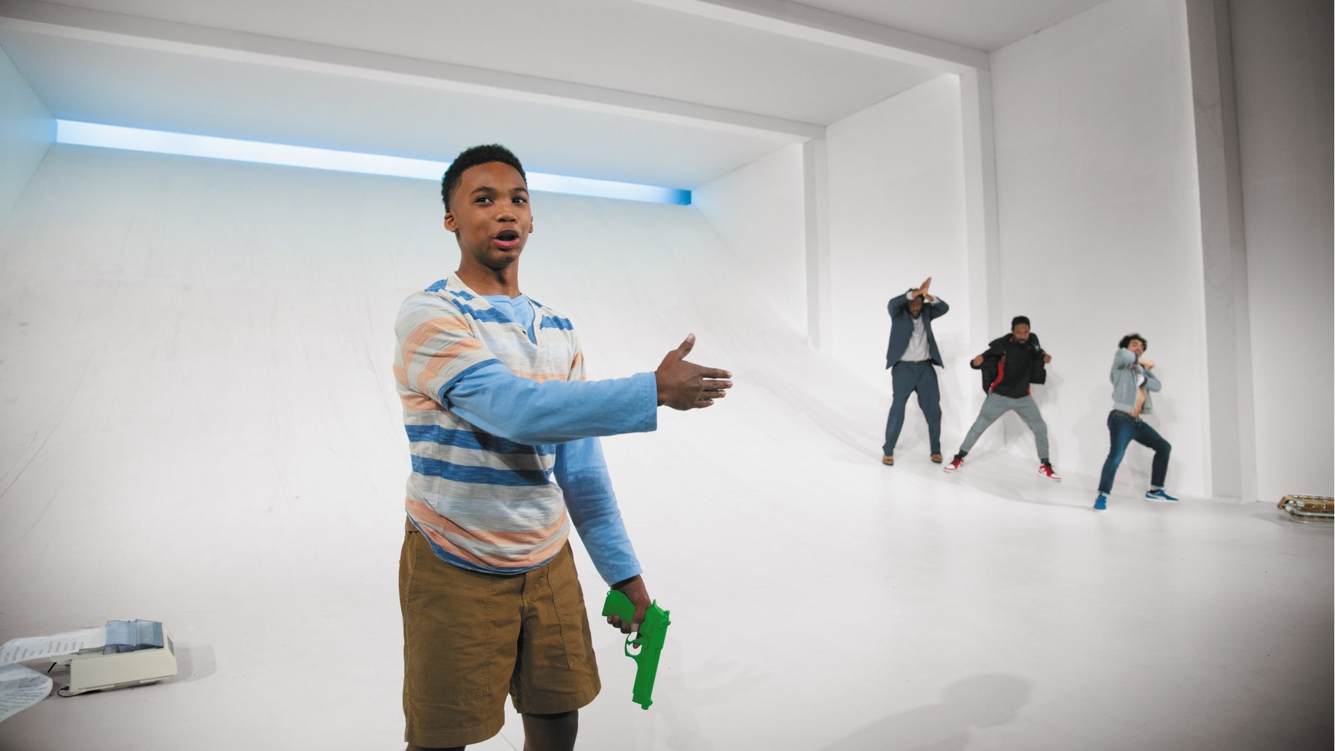 A view of four young men from the back running up a stark white ramp