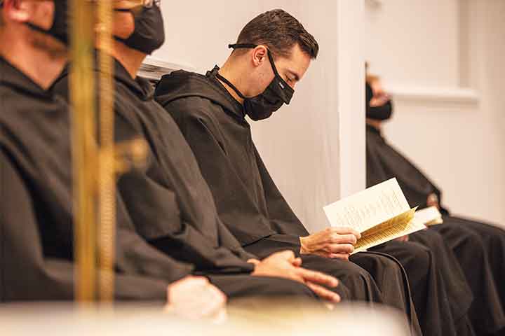Deacon Bill Gabriel sitting in a church pew, reading