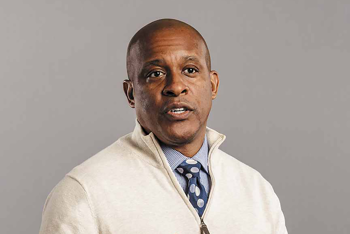 Malcolm Grace standing mid-conversation