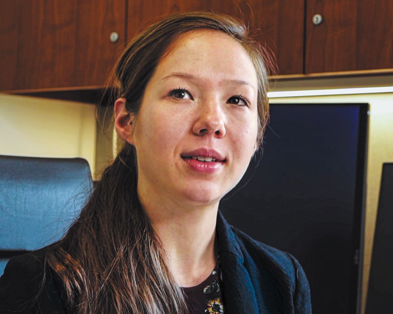 Headshot of PhD student Jennifer Muller wearing a blazer and ponytail