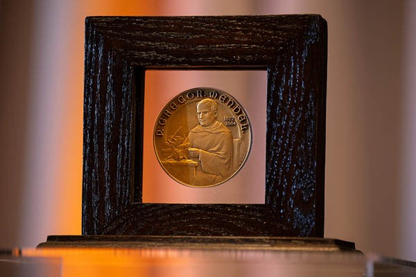 The Mendel Medal against a blurry backdrop