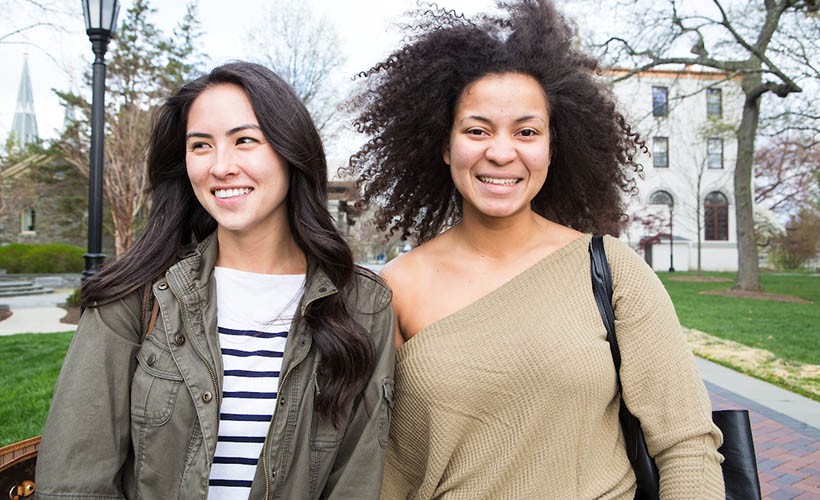 Two female students smiling at the camera