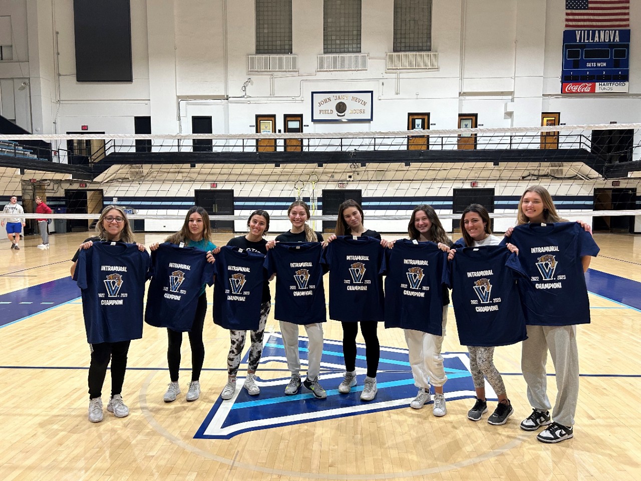 Female students posing for volleyball champion photo