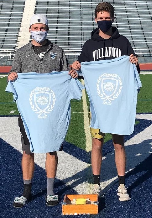 Two male students posing for washers champs photo