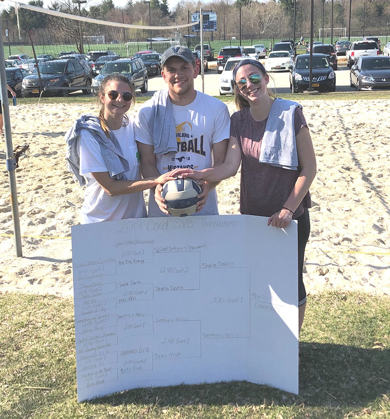 Students posing for sand volleyball champion photo