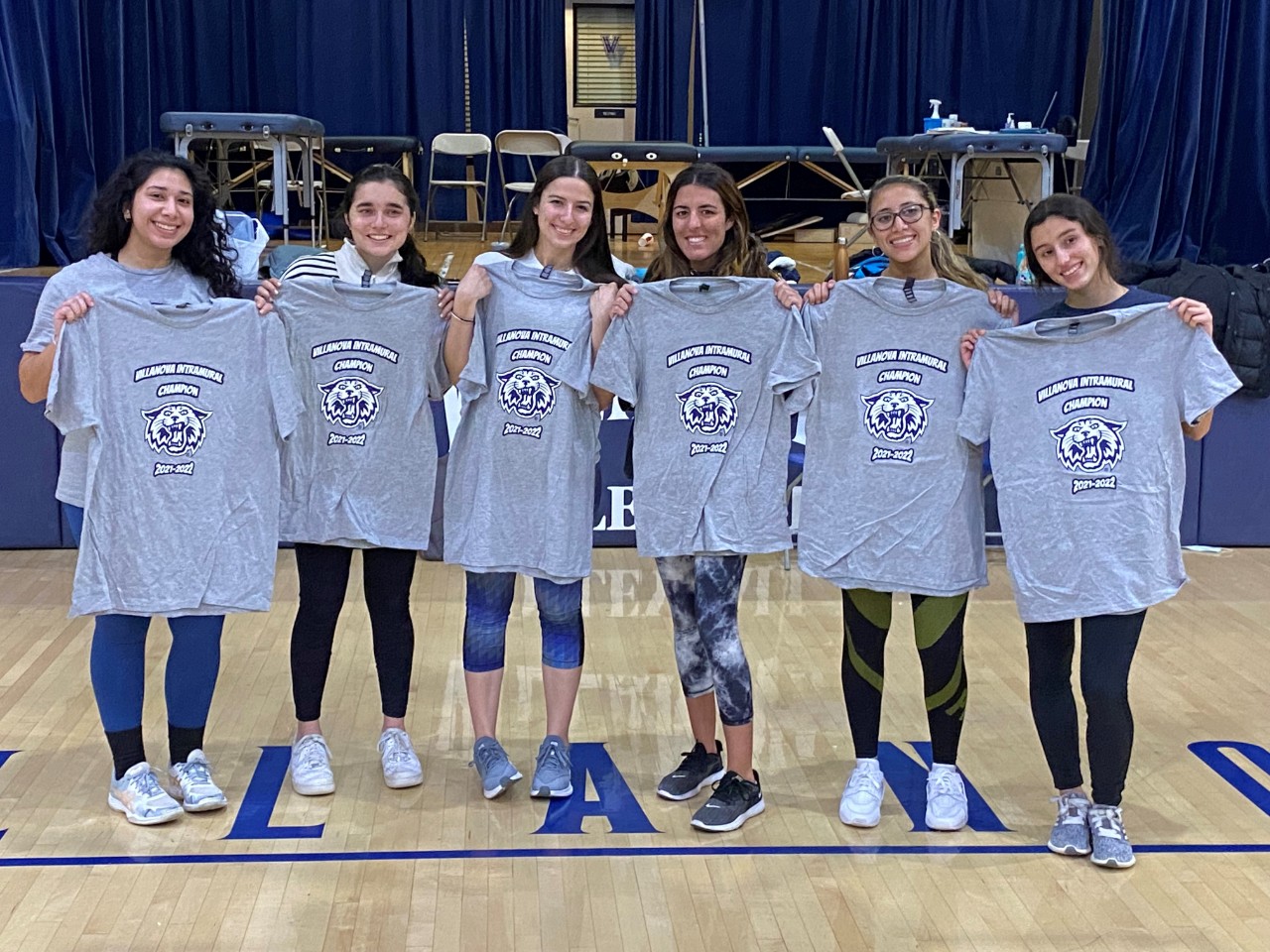 Female students posing for dodgeball champion photo