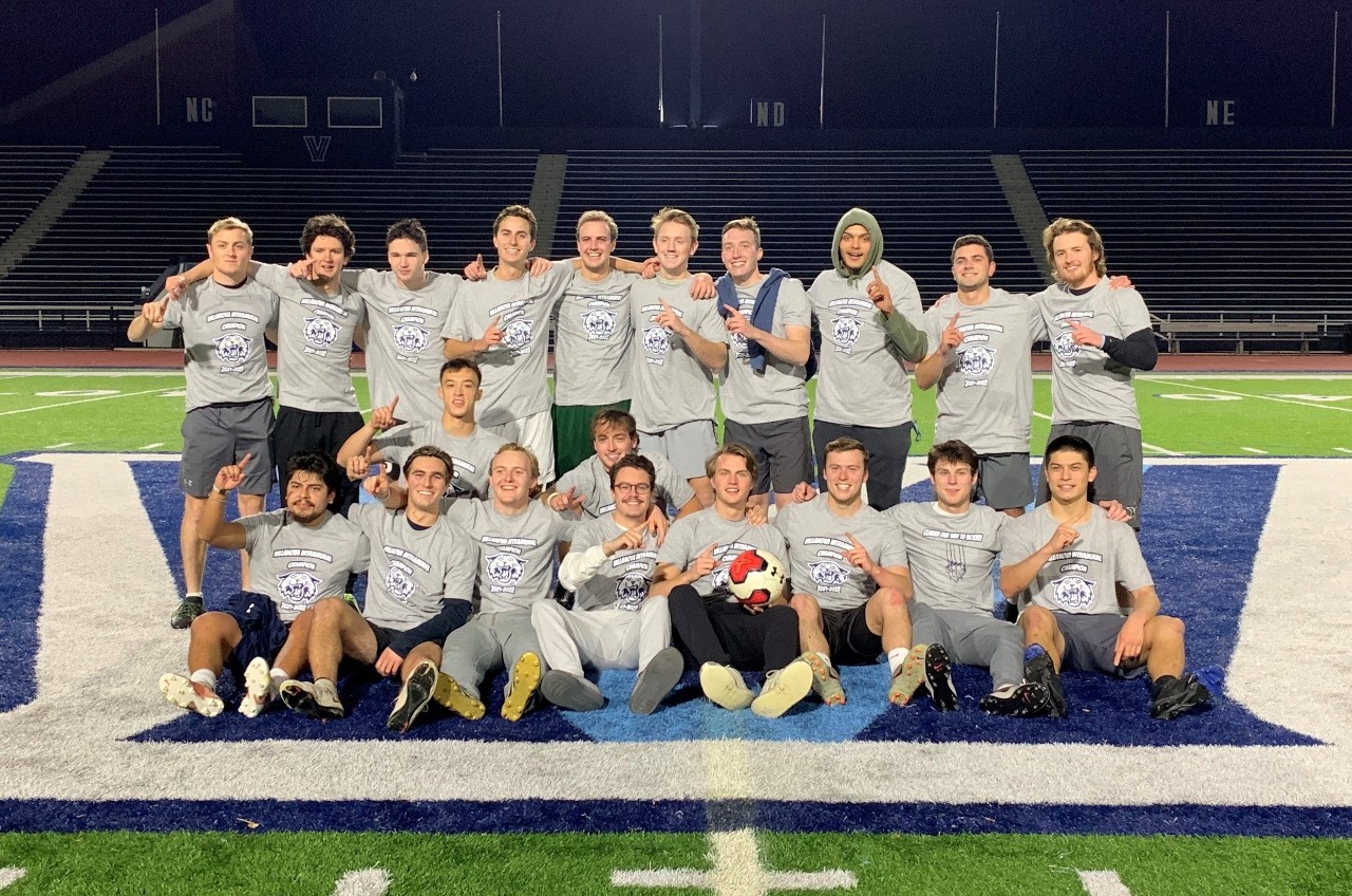 Male students posing for soccer champion photo