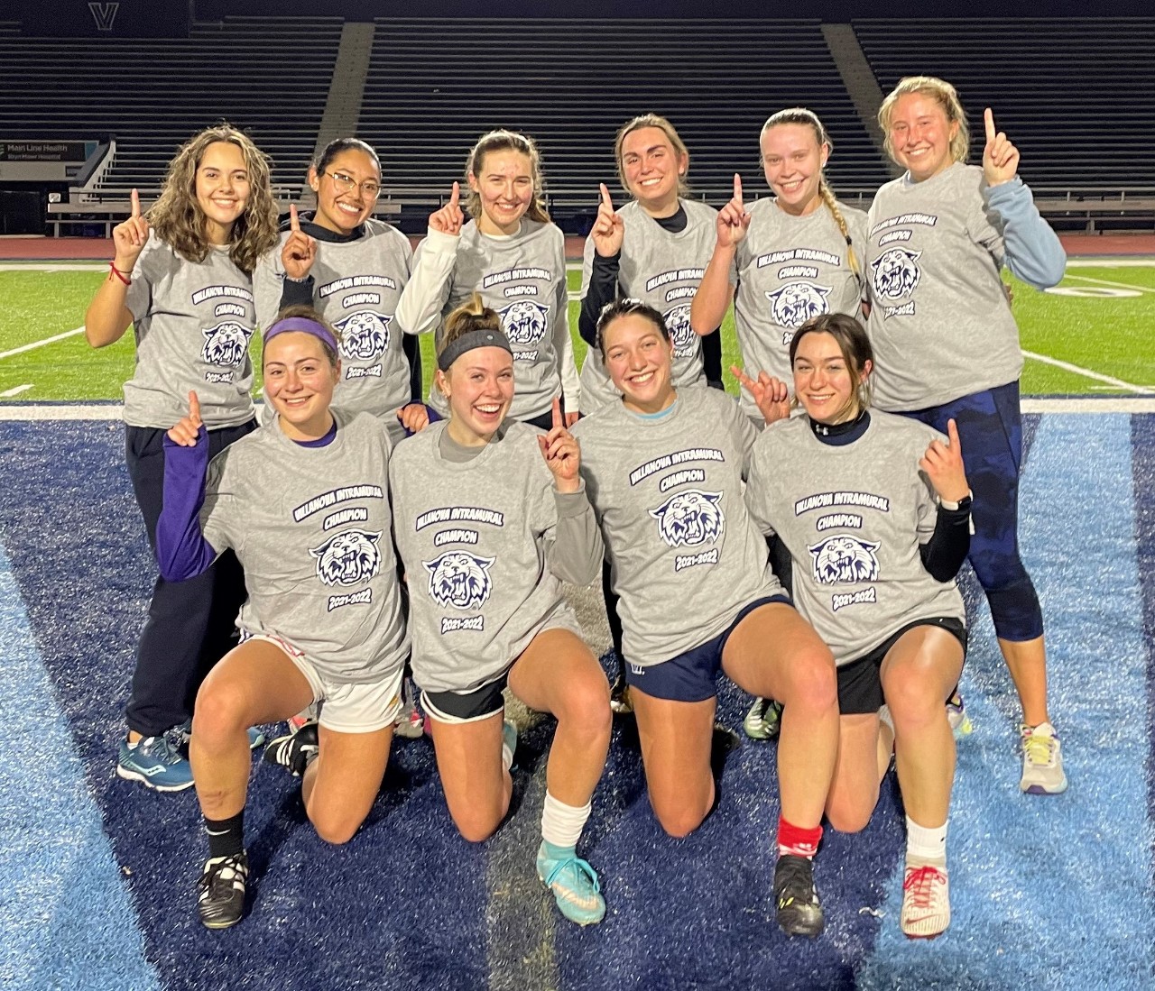 Female students posing for soccer champion photo
