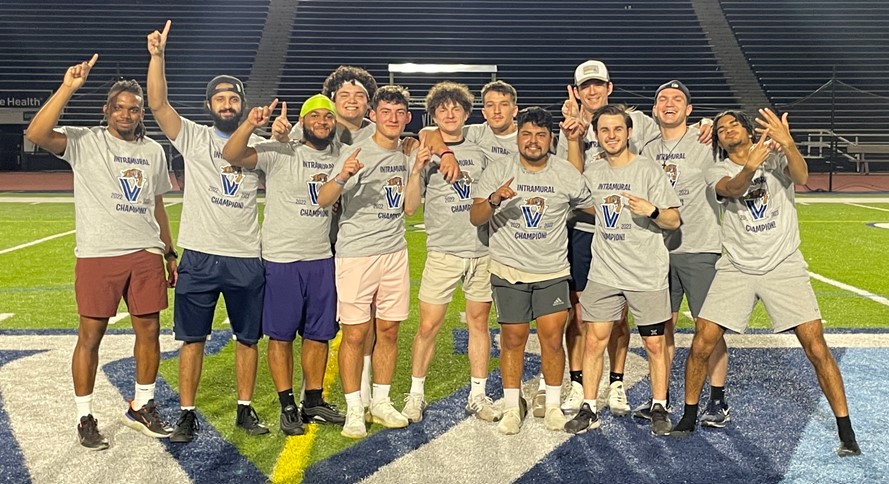 Male students posing for kickball champion photo