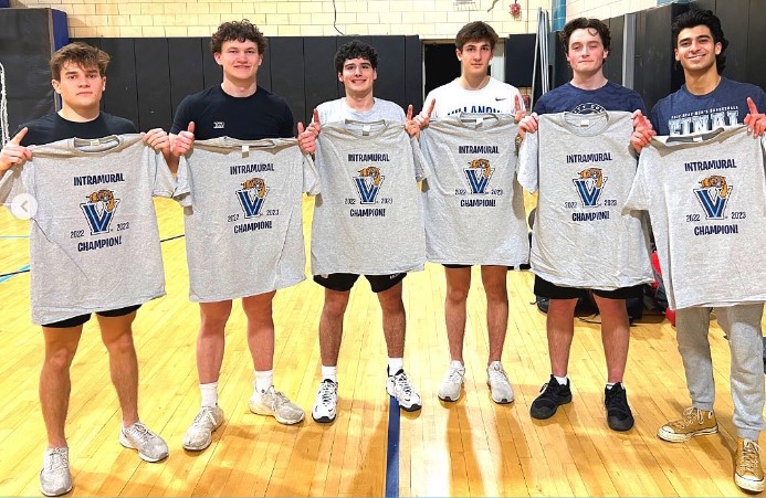 Male students posing for handball champion photo