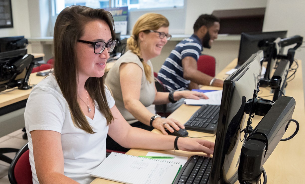 Graduate students working in a computer science lab