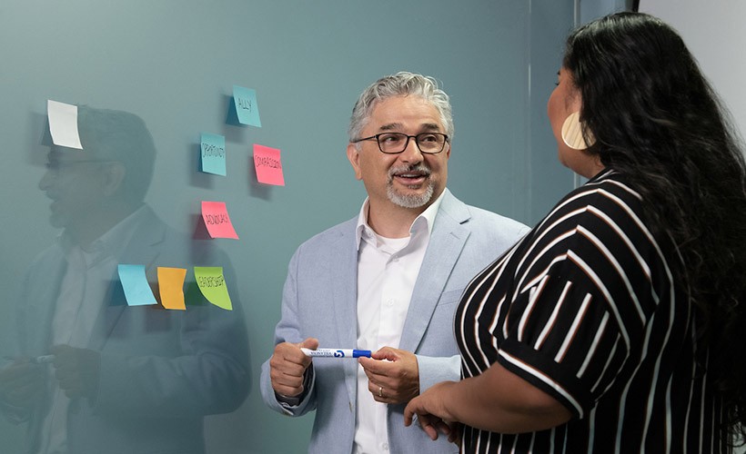 DIVERSITY, EQUITY & INCLUSION Edward Fierros, PhD, associate dean of Diversity, Equity and Inclusion, talks with a student.