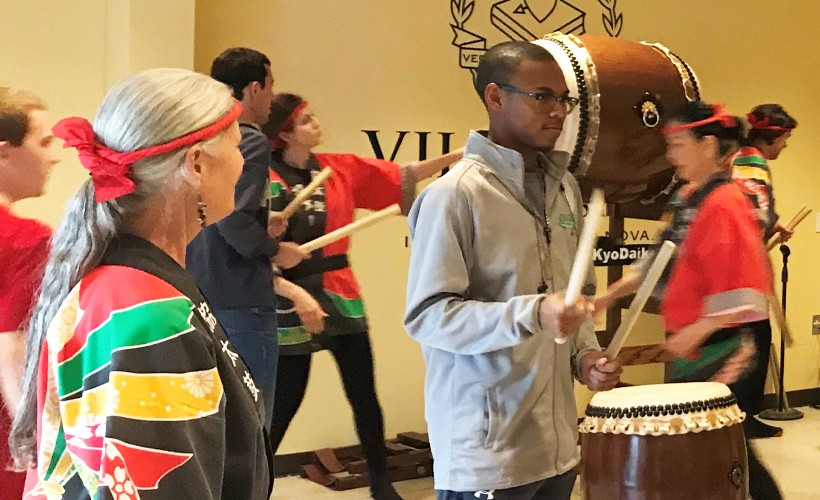 Asian Studies Student participating in a Taiko demonstration.