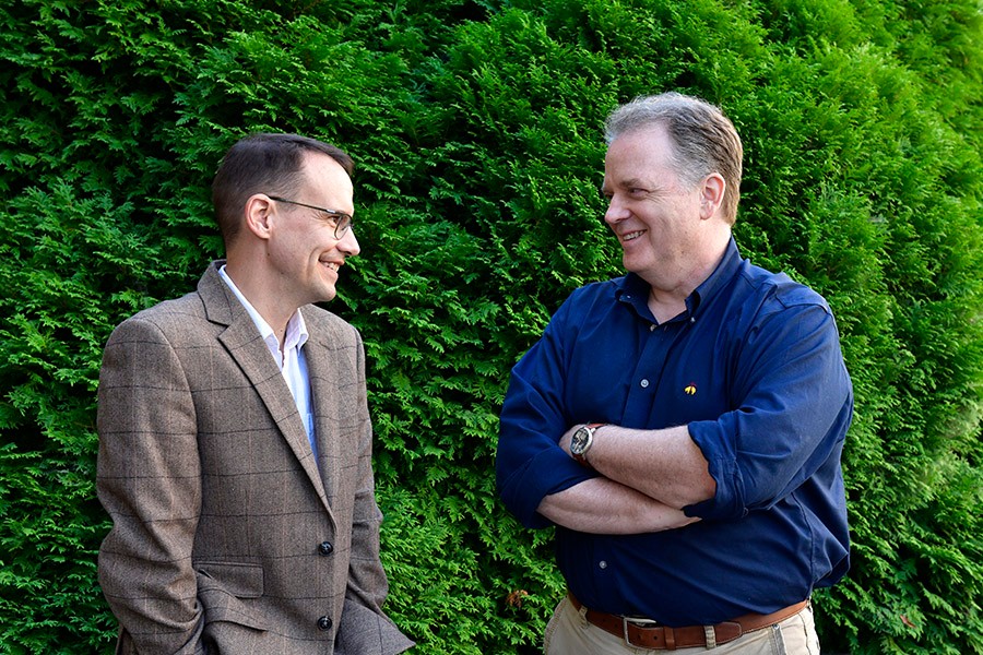 Two professors talking outside.t Two professors talking outside.