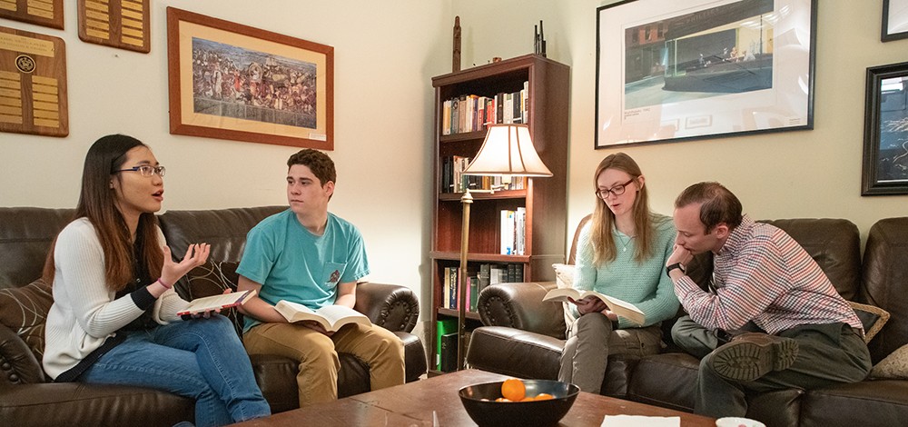 Students sitting on couches and discussing literature Students sitting on couches and discussing literature