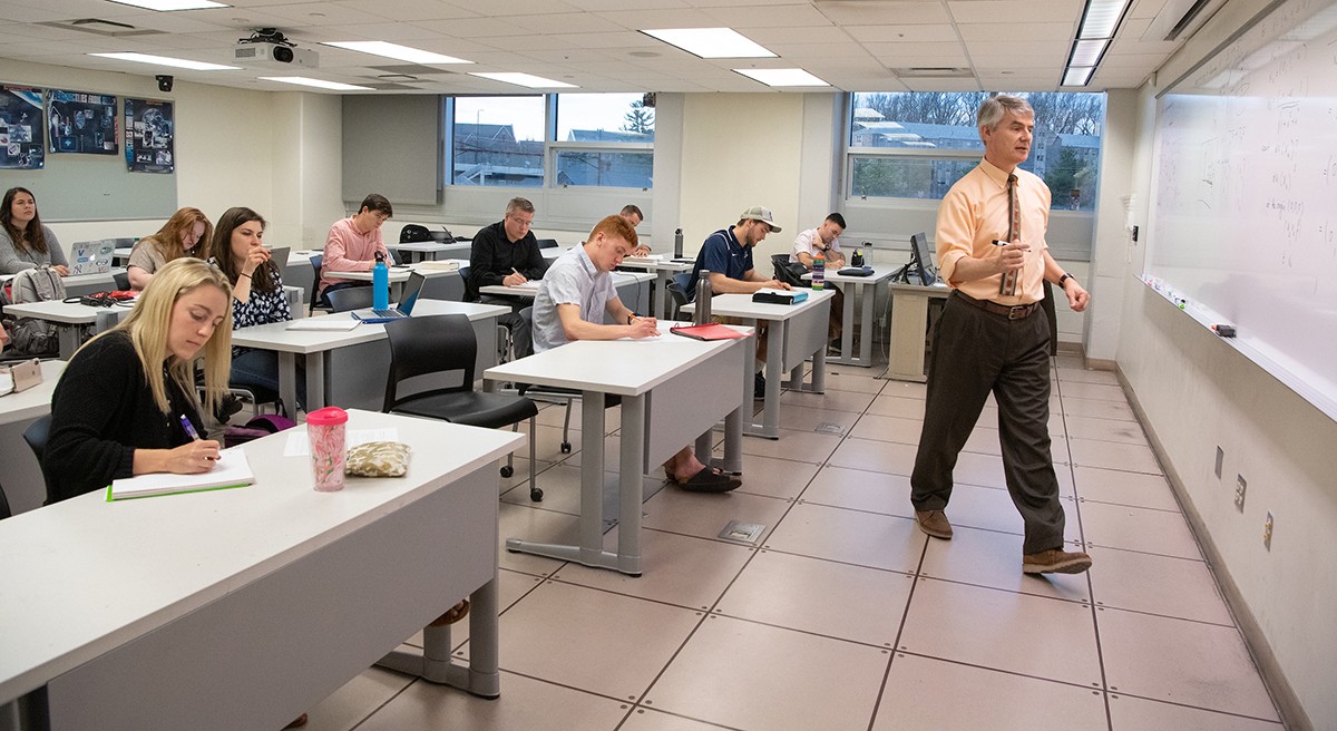 Professor instructs his graduate mathematics class Professor instructs his graduate mathematics class