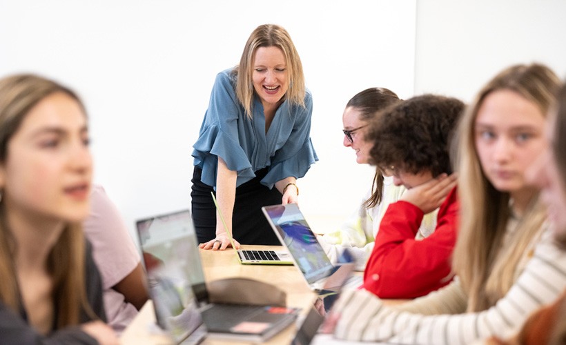 Students and professor conversing in a political science class.