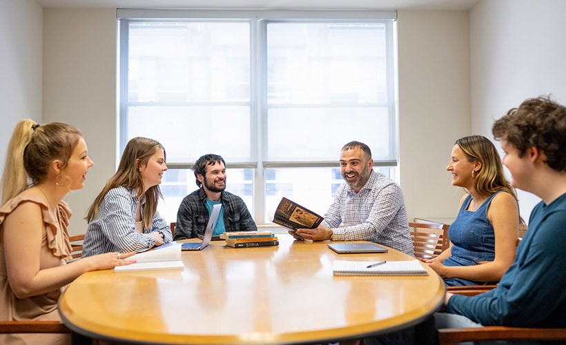 Center for Arab and Islamic Studies Students sit around a table with a professor in discussion.
