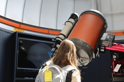 An eclipse watcher views the early moments of the celestial event through the telescope in Villanova's observatory