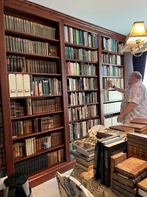Dr. Bauer searches for a book on one of the bookcases in his home library. His collection of 20,000 herpetology texts—and his knowledge of each of them—are inavulable and otherwise inacessible resources for students. Dr. Bauer searches for a book on one of the bookcases in his home library. His collection of 20,000 herpetology texts—and his knowledge of each of them—are inavulable and otherwise inacessible resources for students.
