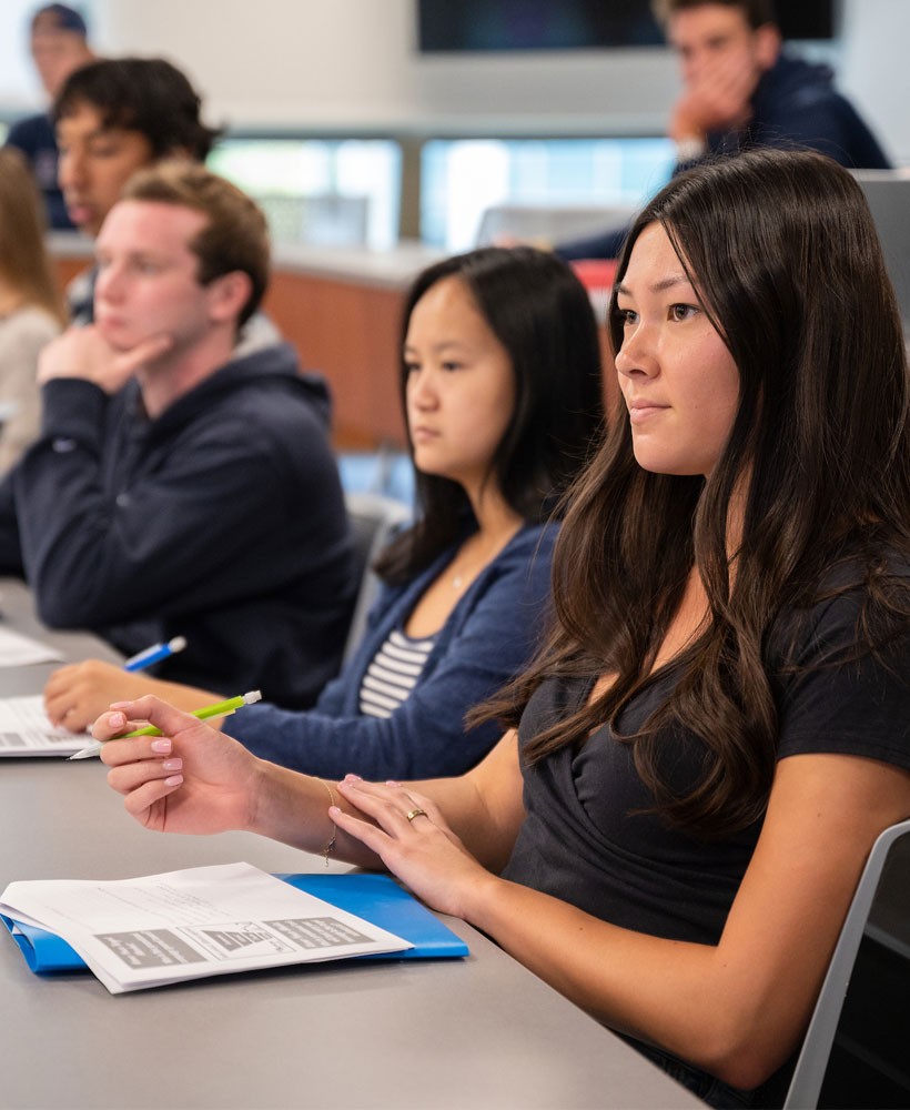 Students in class taking notes