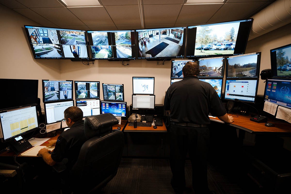Campus security watch Public safety officers at a desk with computer monitors