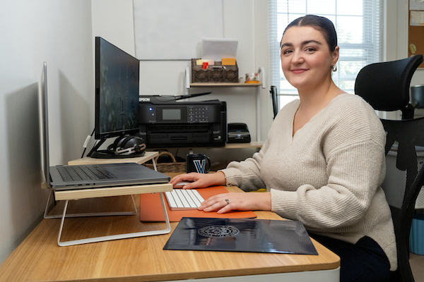 woman in a home office looking at the camera smiling