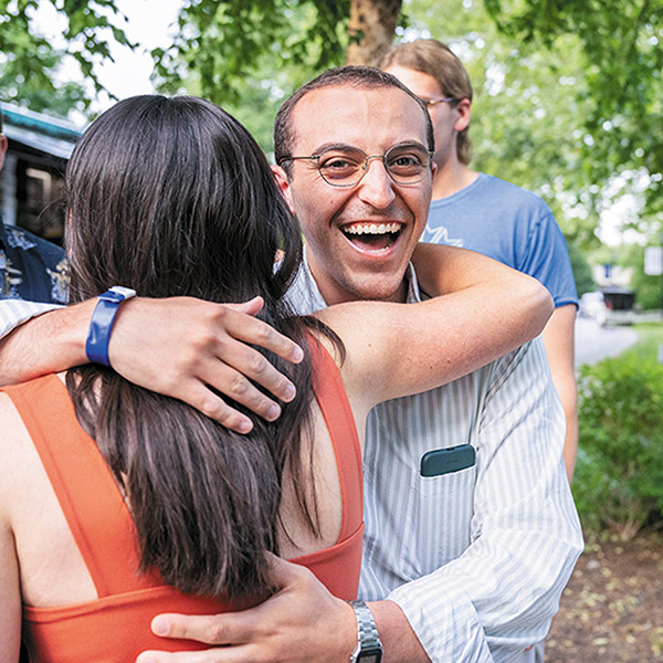 a hug between two alumni