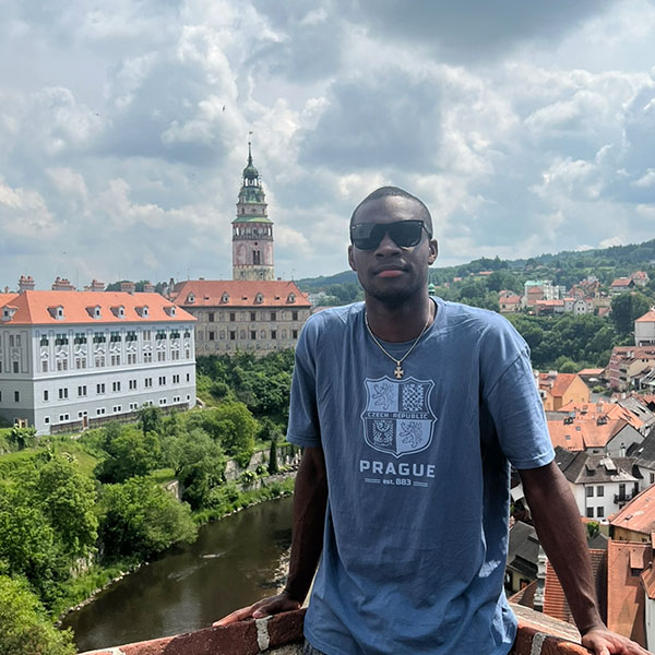 an outdoor portrait of male Villanova student wearing a Prague T-shirt