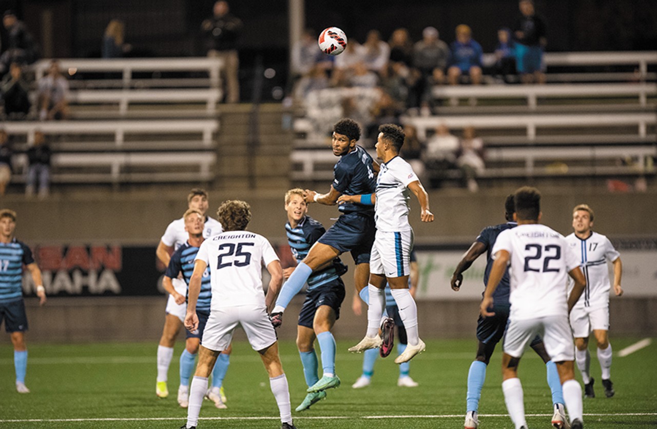 two soccer teams compete on the field