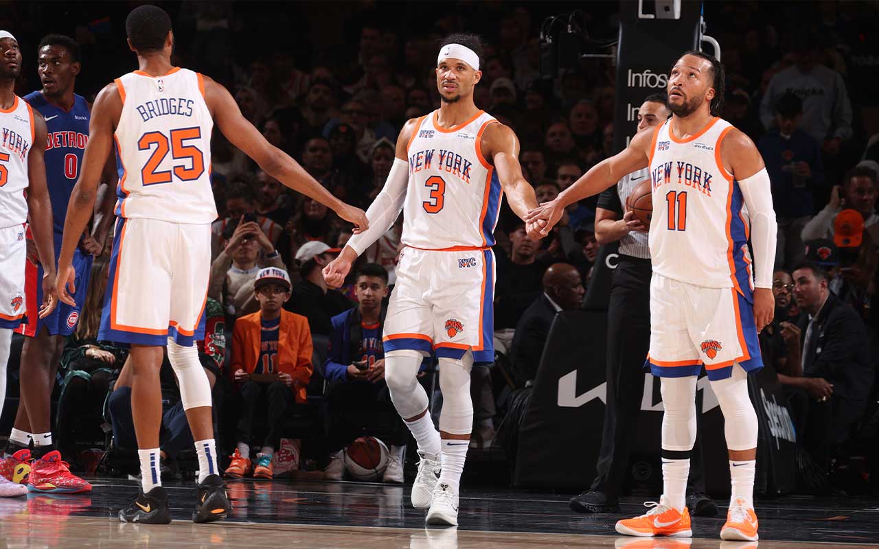 New York Knicks players Mikal Bridges, Josh Hart, and Jalen Brunson on the basketball court during a game.